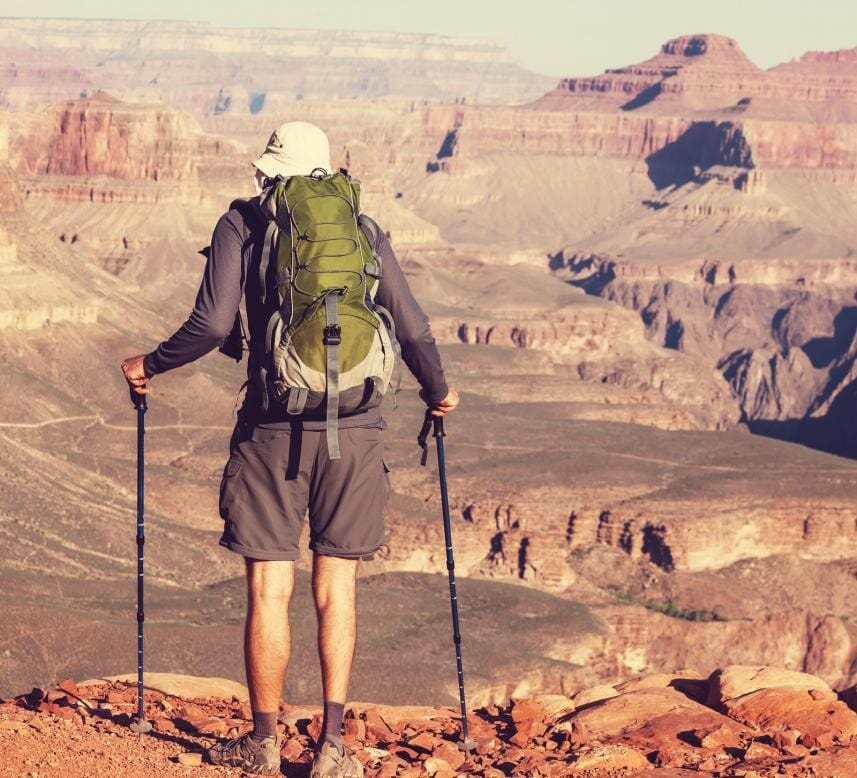 Male hiker standing on south rim of Grand Canyon